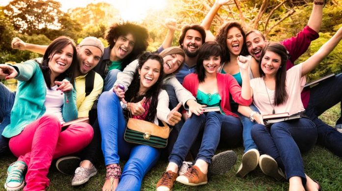Multi-ethnic group of young students having fun at university campus